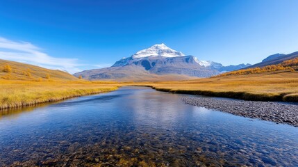 A serene river flows through an autumnal landscape, reflecting a snow-capped mountain. Golden grasslands flank the river. The image is high-resolution, with sharp details and bright lighting. The sty