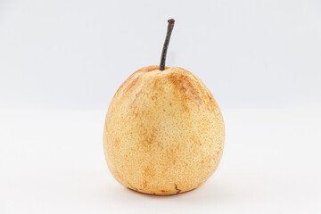 A ripe pear standing upright on white background
