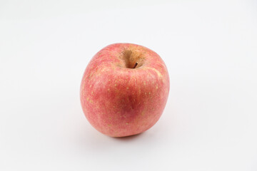 Crisp red apple centered on white backdrop