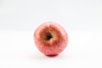 Red apple showing off its top side stem