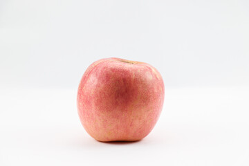 Small red apple leaning slightly to the left