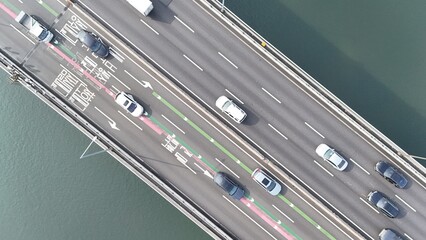 Obraz premium Orderly Morning Traffic Flow on Bridge Captured by Drone