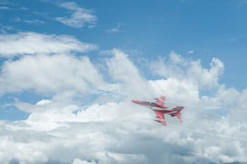 Fighter jet flies through the sky on technology background