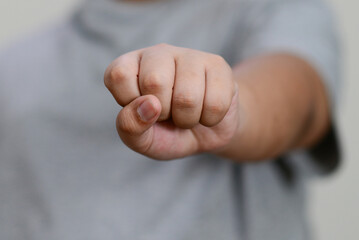 The child's hand is clenched into a fist.
