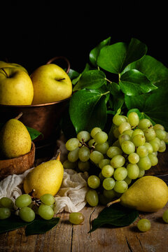 View of apples, pears and grapes with green leaves