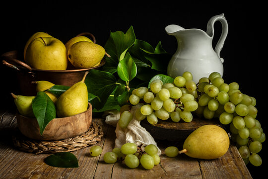 Still life with apples, pears and grapes with a jug