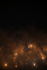 Stunning and colorful fireworks display in the night sky with smoke during explosion. Real fireworks background. Abstract of real shining fireworks against black background. for celebration.