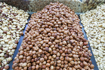 Peeled hazelnuts are lying on the market for sale. Hazelnut kernels close-up.