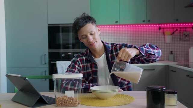 Featuring smiling mixed-race man in plaid shirt enjoying relaxed start day. Cozy Breakfast with Cereal and Plant-Based Milk in Stylish Kitchen, Daily Vlog Moments, Aesthetic Lifestyle Content at Home