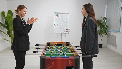 Office Foosball Game Between Colleagues During Break Time
