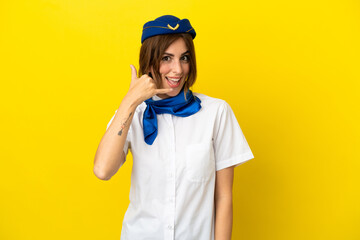 Airplane stewardess woman isolated on yellow background making phone gesture. Call me back sign