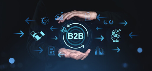 B2B business strategy concept with digital icons and hands on dark background.