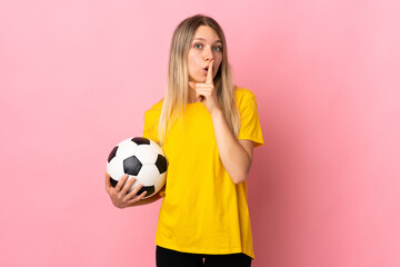 Young football player woman isolated on pink background doing silence gesture © luismolinero
