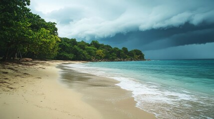 Obraz premium Tropical beach with turquoise water and dark storm clouds approaching coastline.