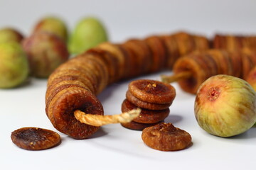 Dried and fresh figs on a white background, highlighting their color and texture
