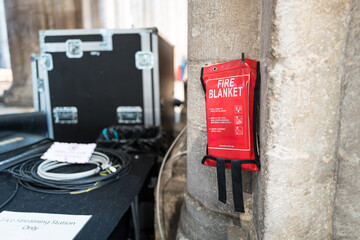 Shallow focus of a typical emergency fire blanket seen attached to a gothic column in a famous...