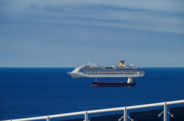 Mega family cruiseship cruise ship liner Favolosa and bunker ship anchored offshore of...