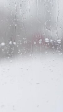 Out-of-focus view of water droplets on a window in winter