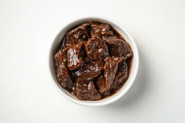 Obraz premium A bowl of tender, dark brown beef stew, rich in savory sauce.