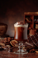 Hot chocolate topped with whipped cream and sprinkled with chocolate chips.