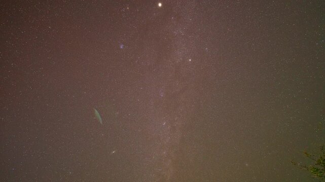 The Milky Way is bright and clear in the dark sky on Doi Chik Chong in Mae Hong Son Thailand. It is a remote place with beautiful nature and fresh air.The Milky Way orbits over a steep mountain range