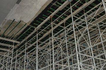 High scaffolding structure under construction beams