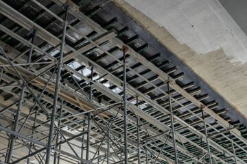 High scaffolding structure under construction beams
