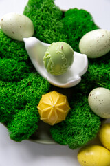 A collection of painted easter eggs celebrating a Happy Easter on a spring day with green grass with copy space.
