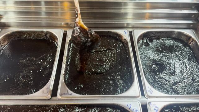 Pomegranate molasses (Rob-e Anar) products displayed for sale in a grocery store