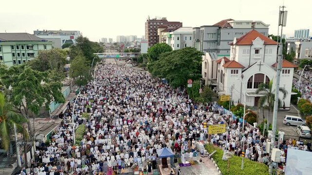 muslim people perform Eid prayers beside a Christian Church in Jatinegara, Indonesia