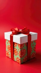Obraz premium Colorful gift box sits atop a crimson background, decorated box, red ribbon white gift box, holiday