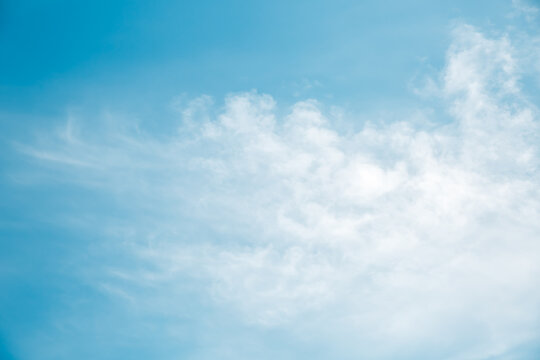 Beautiful light blue sky with fluffy clouds