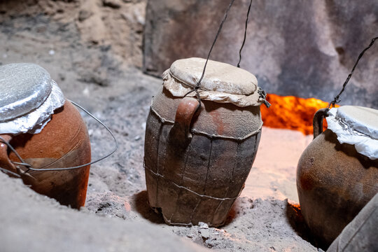 Tanjia cooking vessels deep in ash, heated by the adjacent Hamman hot baths. The food in the clay tangia vessels cooks slowly over many hours. Photographed in the old town medina in Marrakech, Morocco