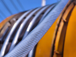 A large wooden spool of high-voltage electric wires is located on the road