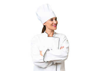 Middle-aged chef woman over isolated background looking side