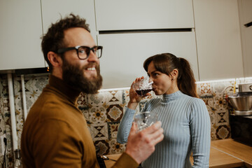 An elegant couple, around 35 years old, is enjoying a cozy evening together.