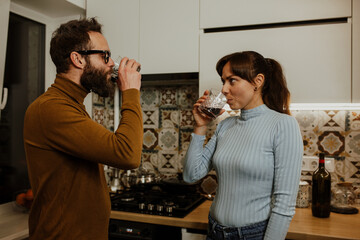 An elegant couple, around 35 years old, is enjoying a cozy evening together.