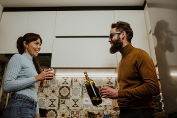 An elegant couple, around 35 years old, is enjoying a cozy evening together.