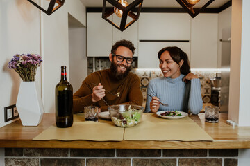 An elegant couple, around 35 years old, is enjoying a cozy evening together.