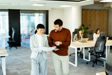 Fototapeta premium Engaging discussion between colleagues in a modern office setting during a productive workday