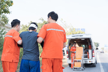 Paramedic, emergency, ambulance staff and medical help. Ambulance staff member assisting injured...