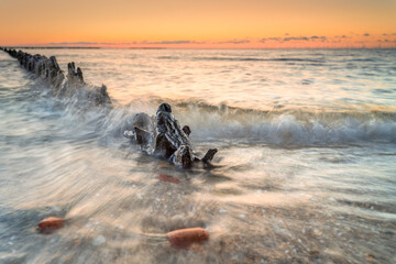 Symmetrical Groynes at Sunset: Coastal Calmness Captured