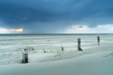 Dusk with view on beach and sea with cloudscape landscape during stormy weather