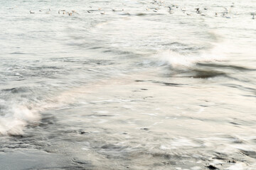 Waves flowing against each other in an alienating pattern on the dutch coast