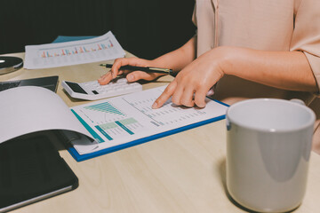 Tax deduction planning concept. Women use a calculator to calculate expenses and taxes to receive...