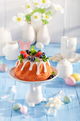 Sweet Easter ring cake surrounded by flowers and eggs.