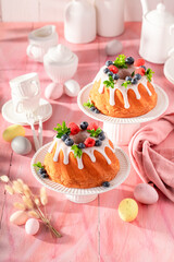 Glazed ring cake for Easter accompanied by eggs and willows.