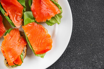 Salmon sandwich red fish seafood appetizer dish fresh tasty gourmet food background on table rustic food top view copy space 