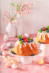 Homemade ring cake for Easter accompanied by eggs and willows.