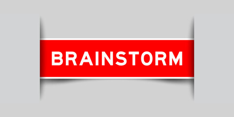 Red color square shape sticker label with word brainstorm inserted in gray background